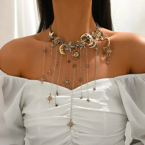 Elegant necklace with celestial designs on a white top