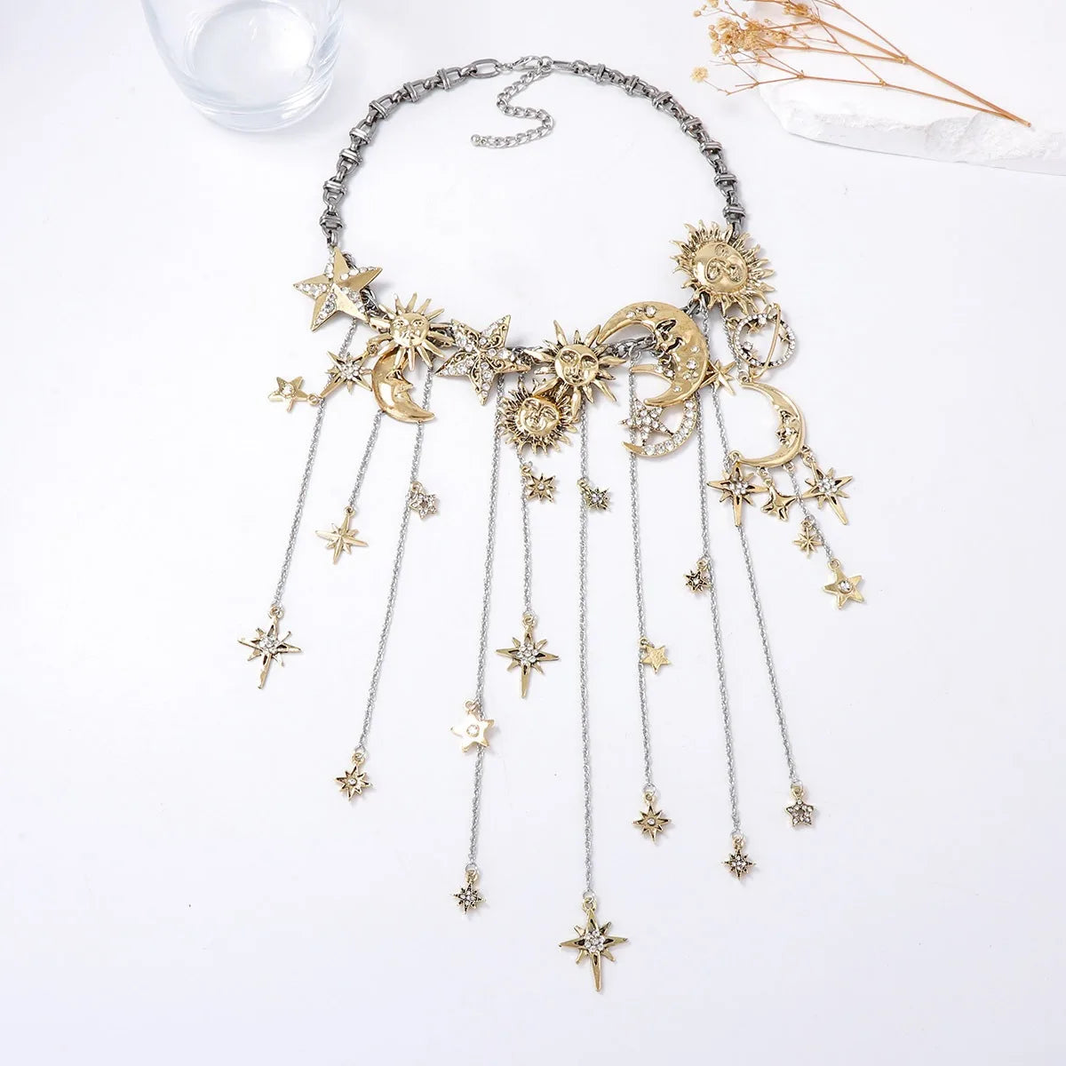 Necklace with star and moon pendants on a white background