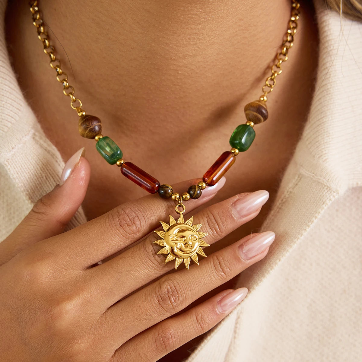 Necklace with sun pendant and colored beads worn by a person