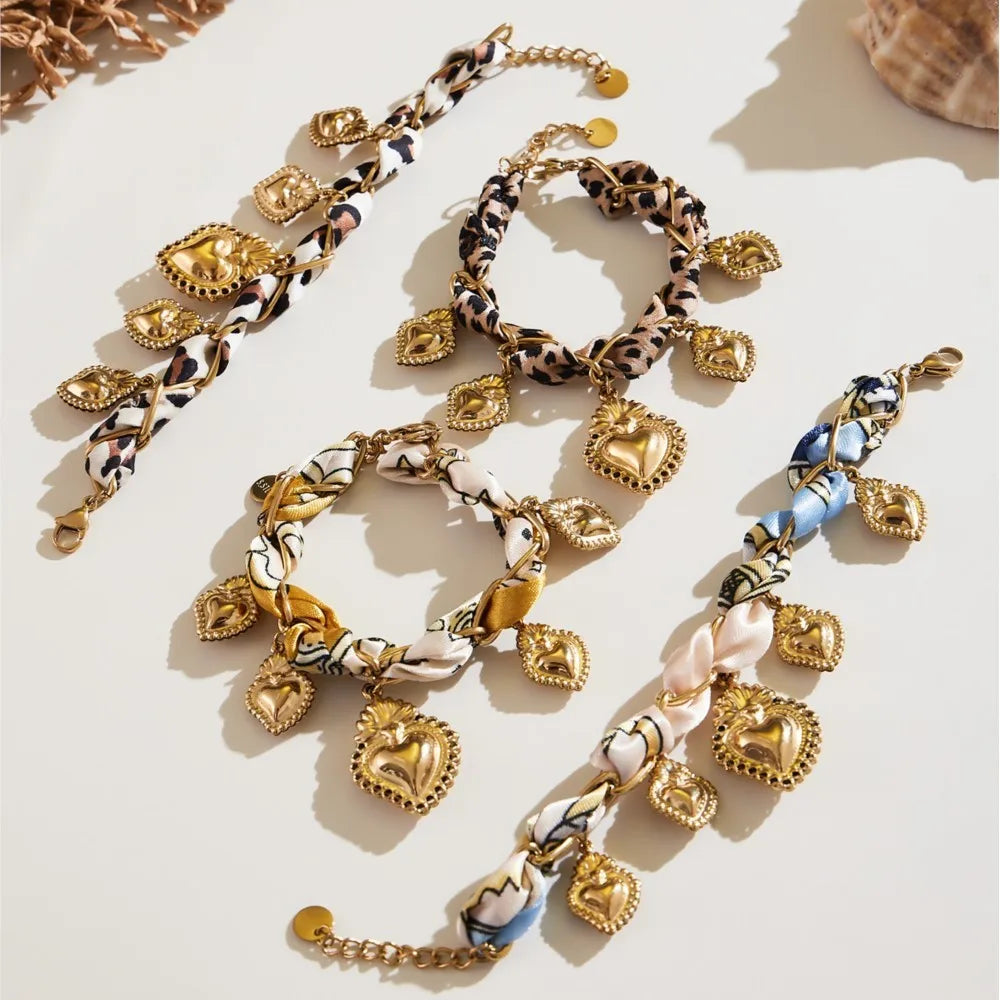 Gold and patterned bracelets on a light surface