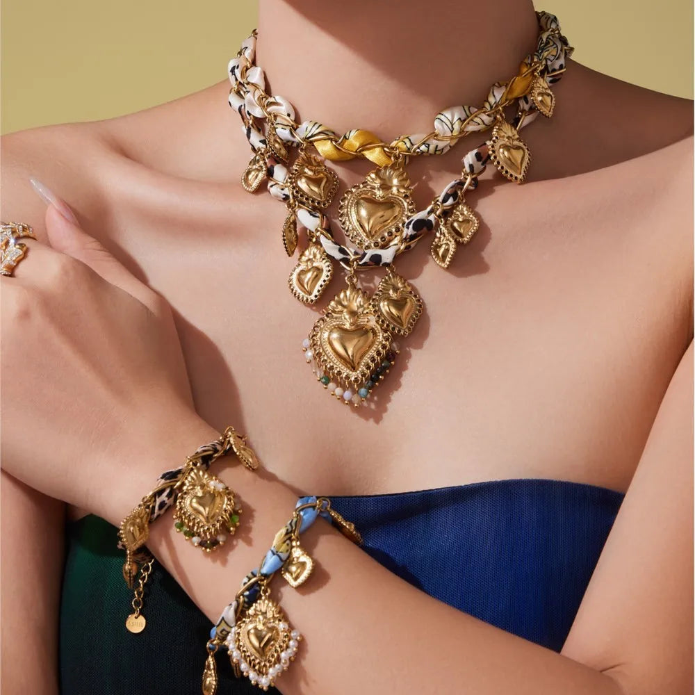 Gold heart charm necklace with multiple pendants and chunky chain statement jewelry for women